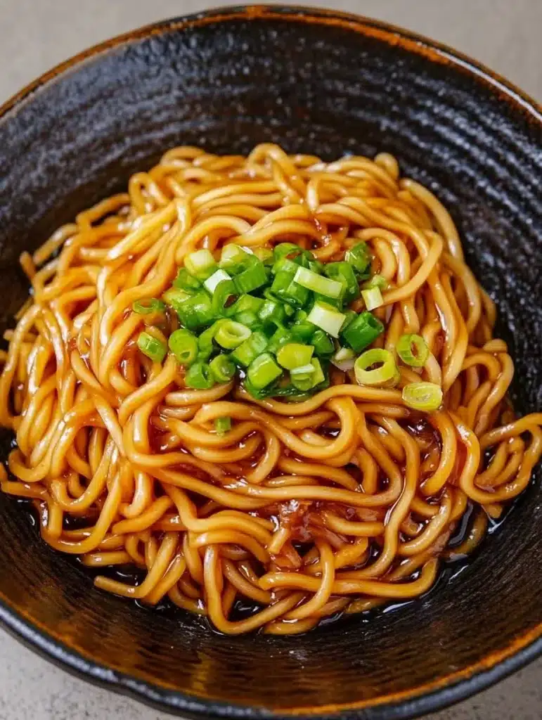 Bowl of Honey Garlic Ramen topped with green onions and sesame seeds