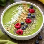 Delicious Healthy Green Smoothie Bowls with tropical fruits and healthy toppings.